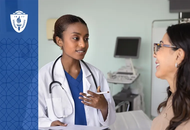 Doctor wearing a white coat and stethoscope talking to woman