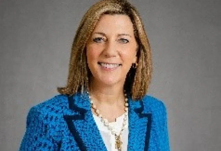 Photo of Julia Mason smiling and looking at the camera wearing a blue jacket