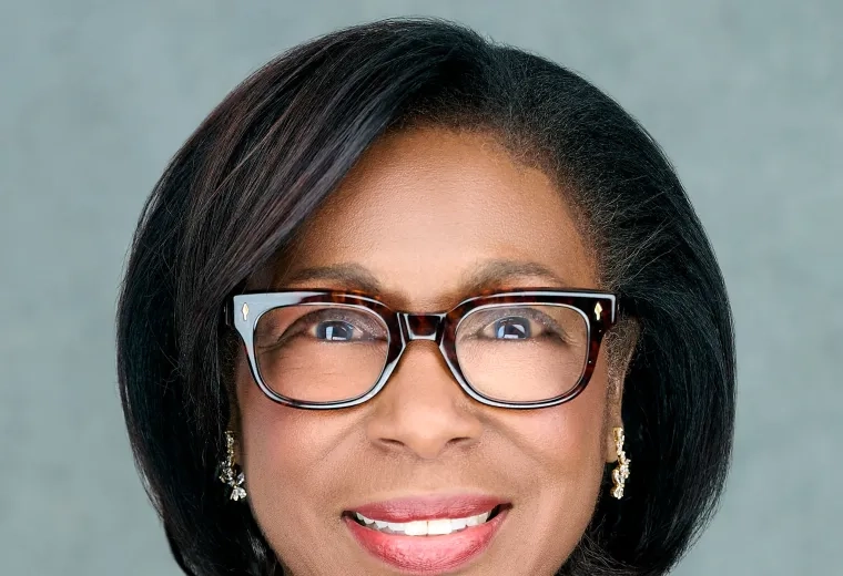 Headshot of Michele Courton Brown wearing glasses, smiling, and looking at camera