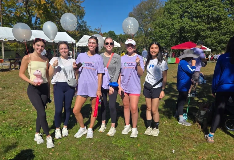 5 women posing with balloons