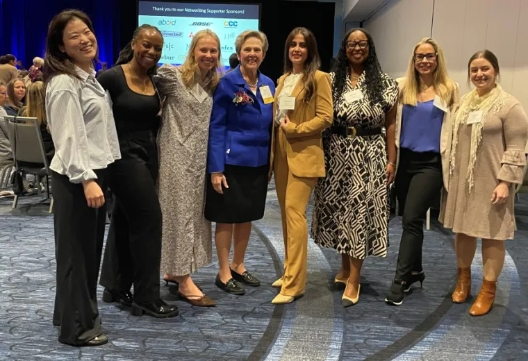 Eight women pose for a photo