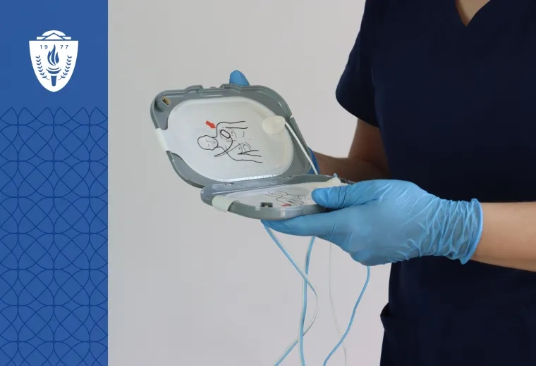 Cardiac technicial holding medical device and wearing blue medical glues