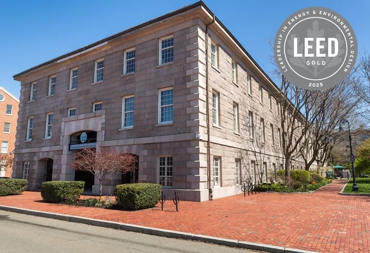 A stone building with a graphic that says LEED Gold 