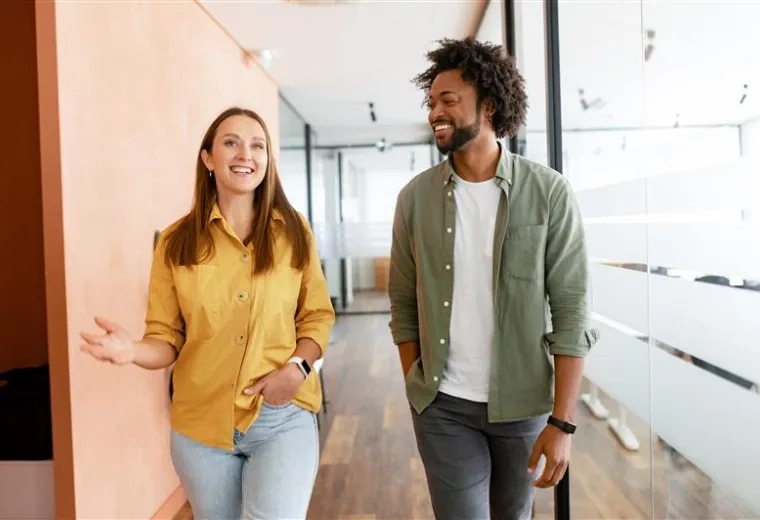 man and woman paraprofessional walk down a hallway