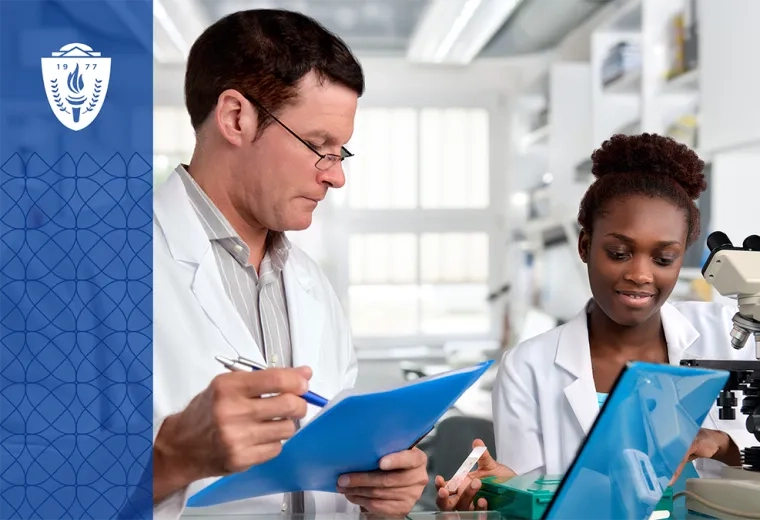 Man and woman wearing lab coats standing in a science lab in front of a microscope and test tubes