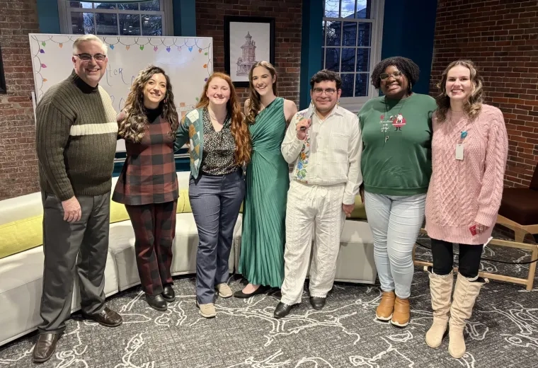 group of men and women smiling