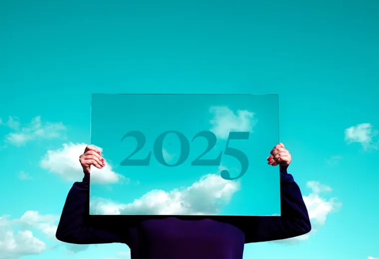 a person holding a mirror in front of their face reflecting the sky