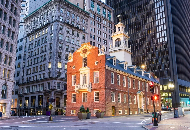 colonial brick building sits among skyscrapers