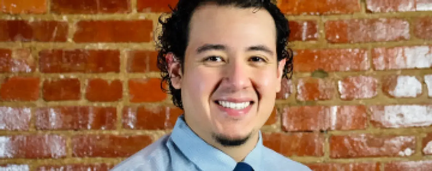 Ramiro Escalera in front of brick wall