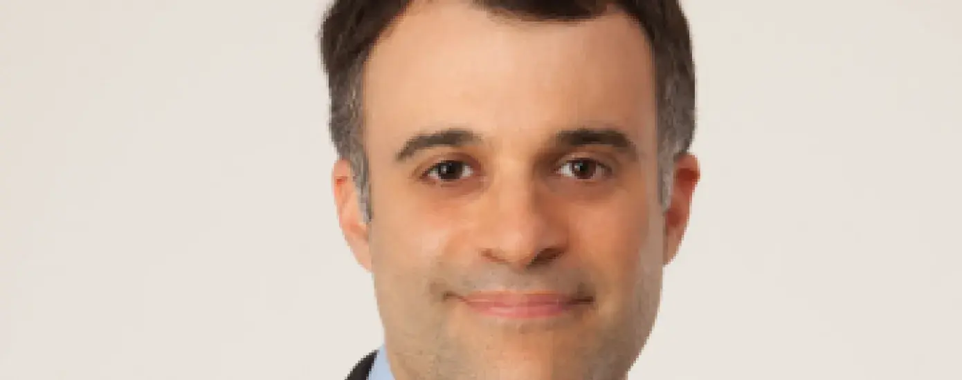 Dr. David Topor center of the image, with beige background.