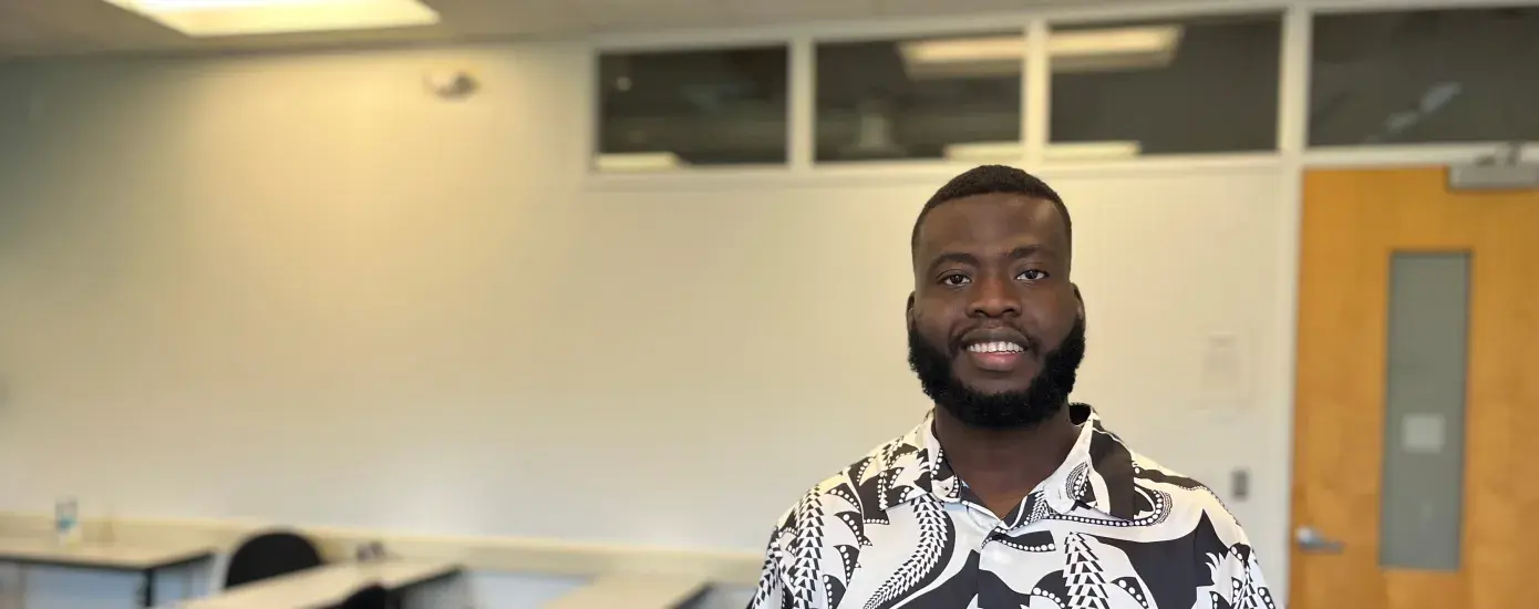 student stands in classroom
