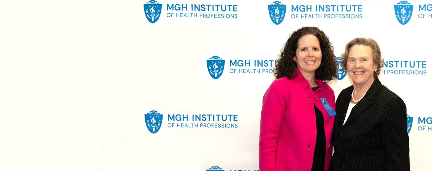 Two women standing and smiling