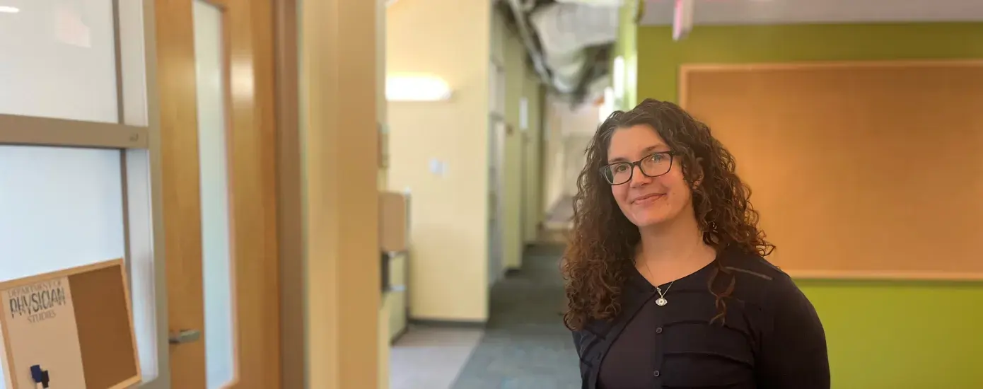 woman smiles and poses in hallway