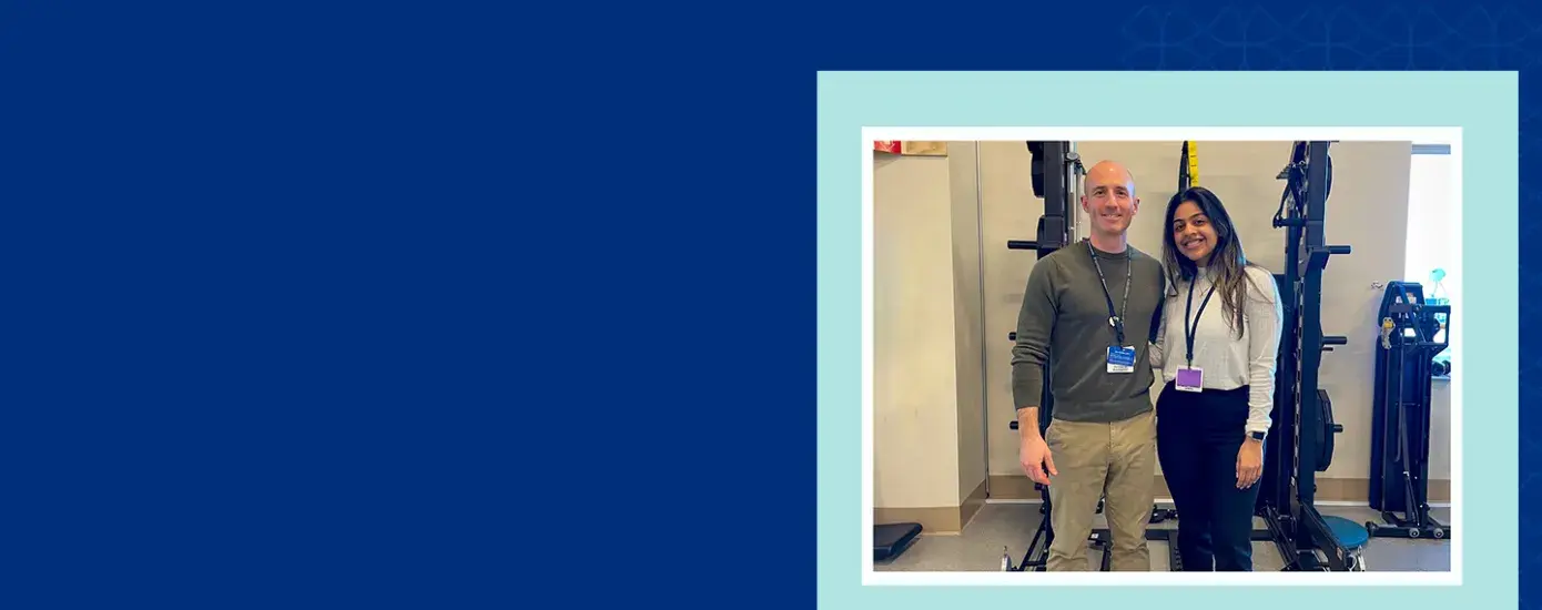 two people pose together in front of a room of exercise equipment