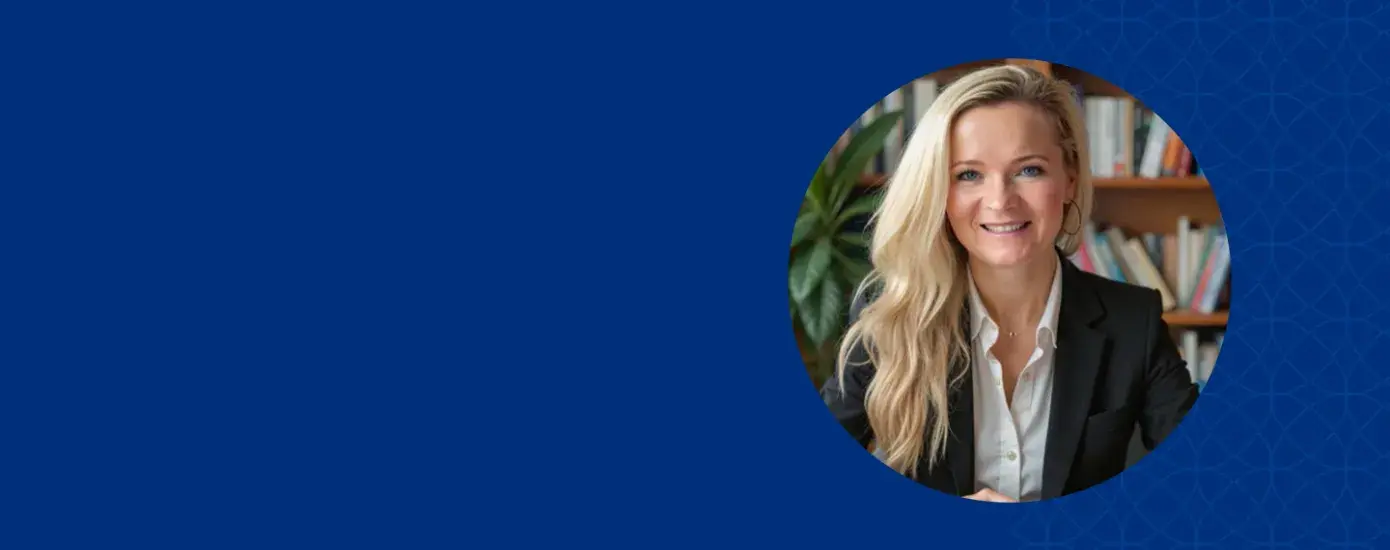 Women with long blonder hair smiling and wearing a black jacket