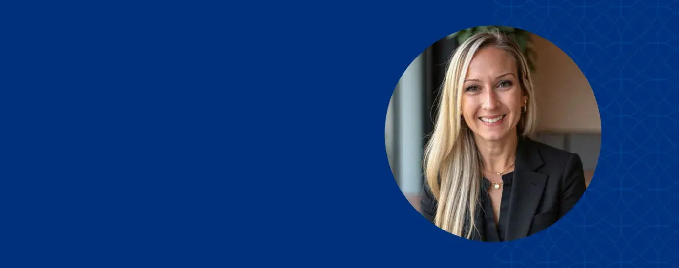 Women with blonde hair smiling and wearing a black jacket