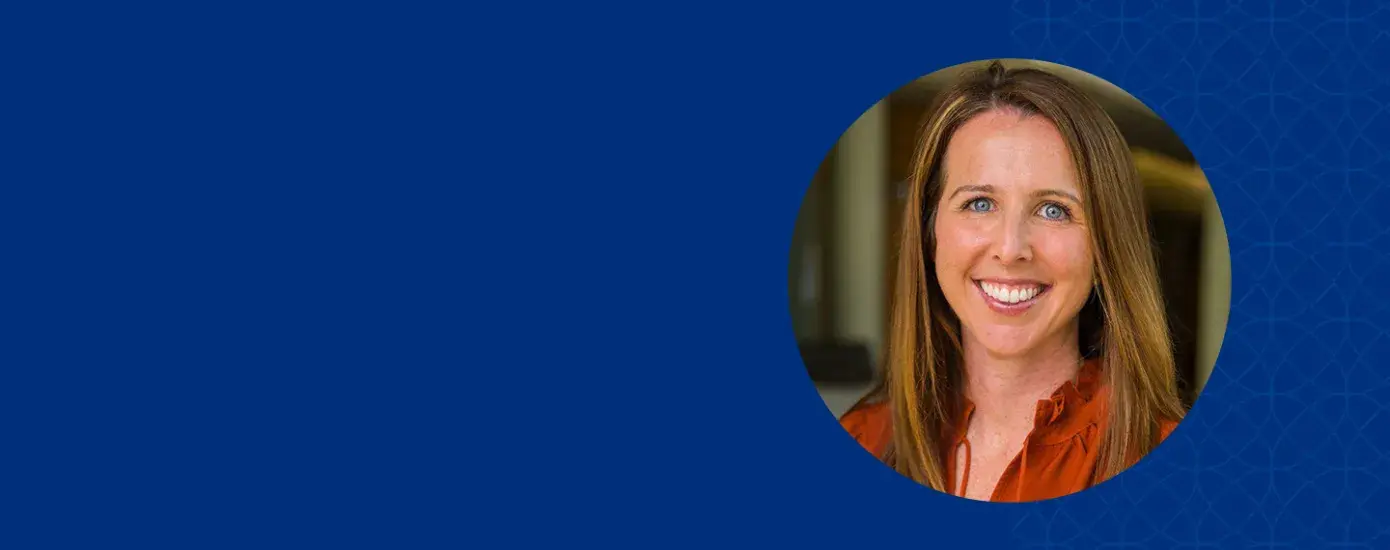 Women with dark blonde hair smiling and wearing a red shirt