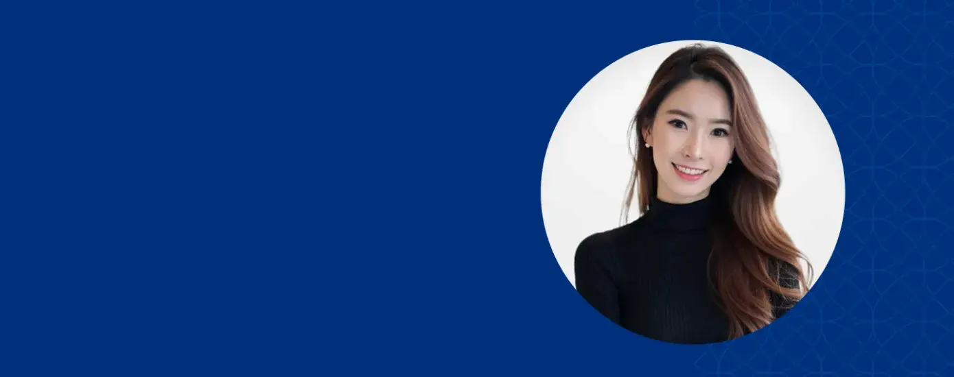 Woman with long brown hair smiling and wearing a black shirt