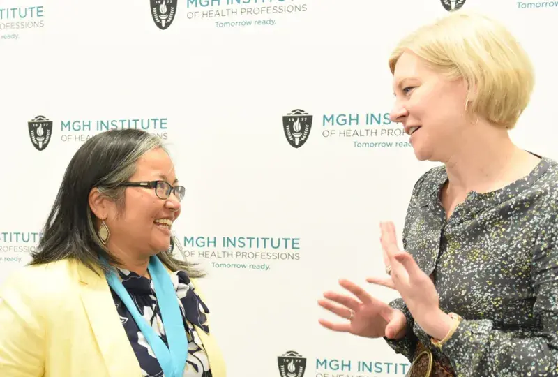 Gayun Chan-Smutko (left) talks with Genetics Counseling Chair Maureen Flynn after receiving the Nancy T. Watts Award for Excellence in Teaching.