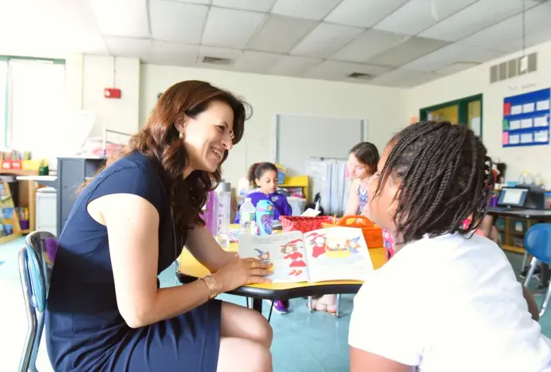 Woman reading to a student