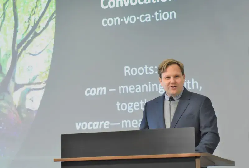 Man speaks at podium