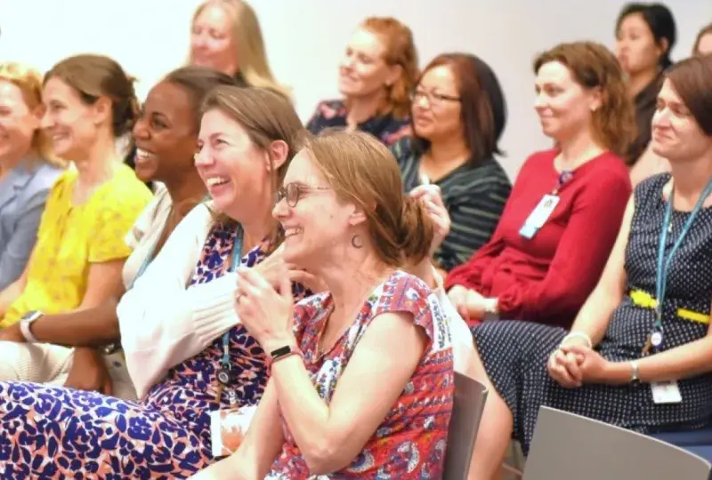 People smiling sitting in chairs