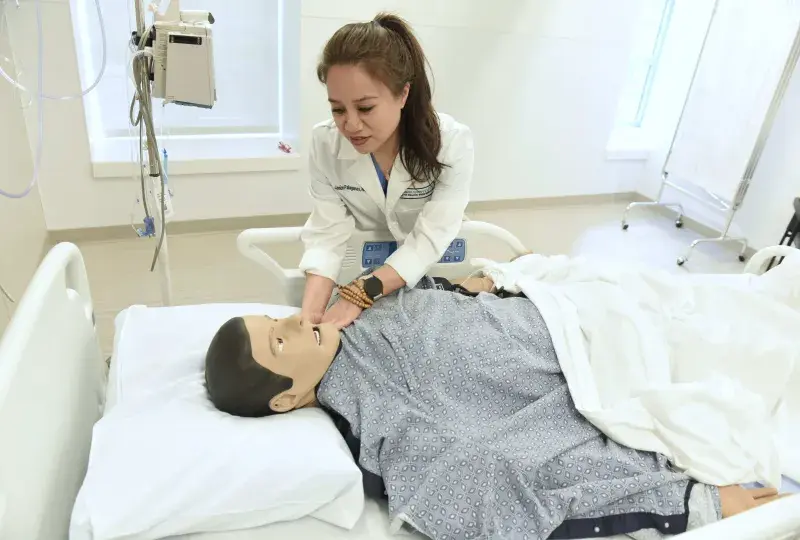 Woman working with a simulation manikin