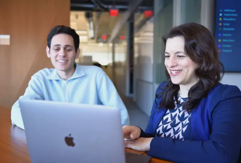 Two people looking at laptop