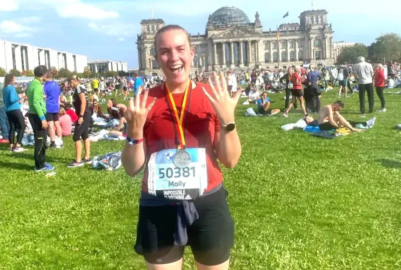 Woman smiles after completing a marathon.