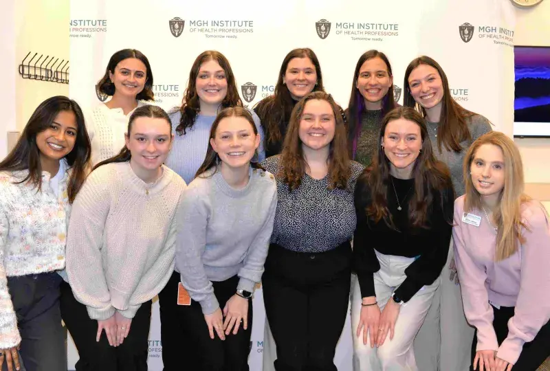 11 students in group smiling
