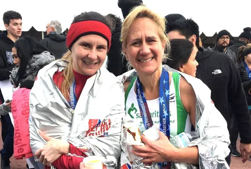 Two women smiling after running marathon