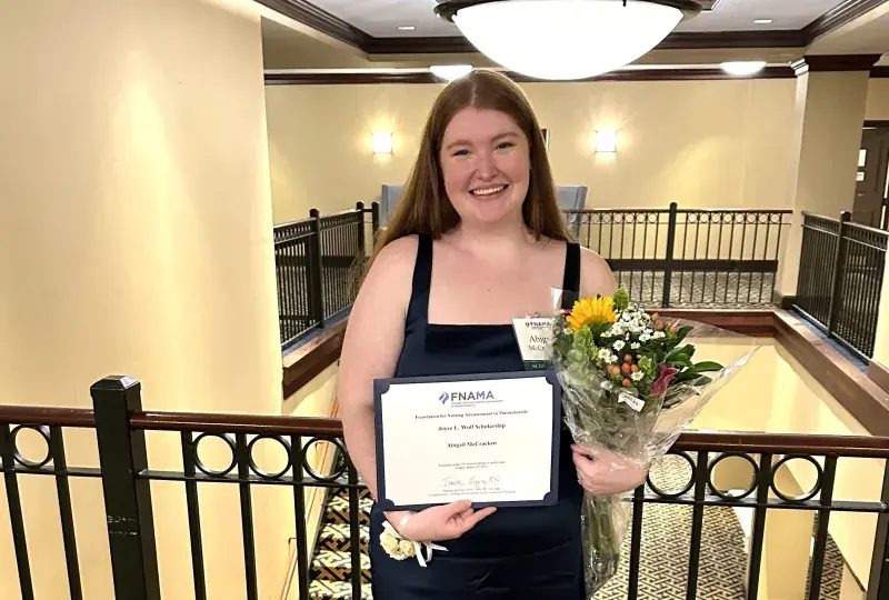 Woman smiling holding a certificate