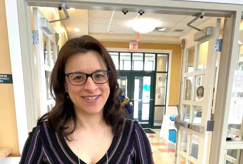 Woman holds an award she received