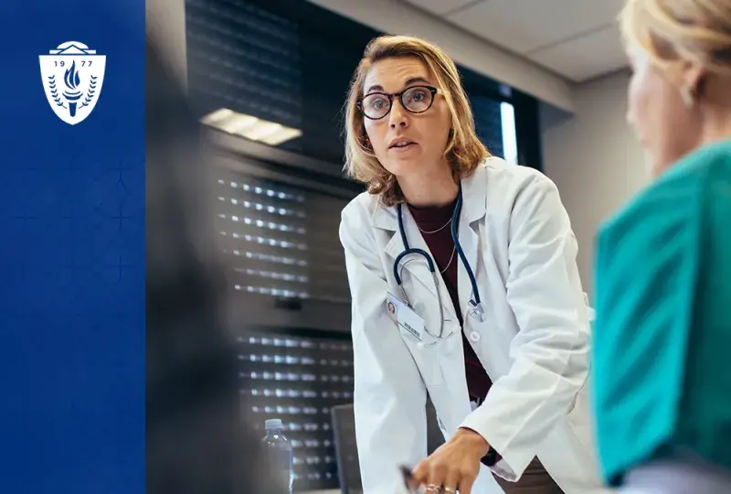 woman in white lab coat and stethoscope leads group of people - nearest one is in scrubs