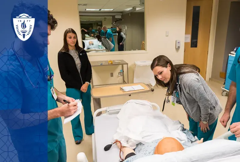 people in scrubs examine a manikin in a hospital bed