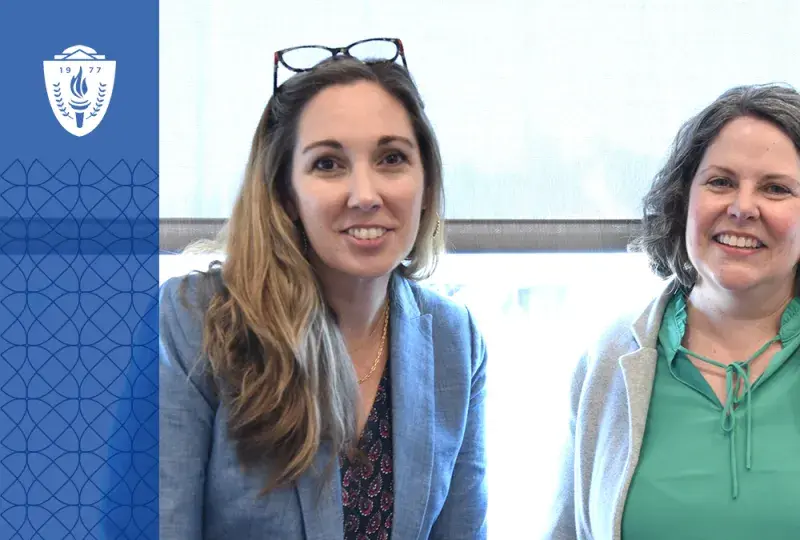 two women smile for the camera