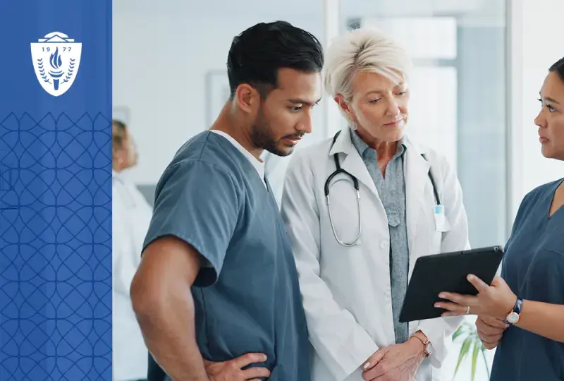 a woman in scrubs shows a tablet to a man in scrubs and an older woman in a lab coat