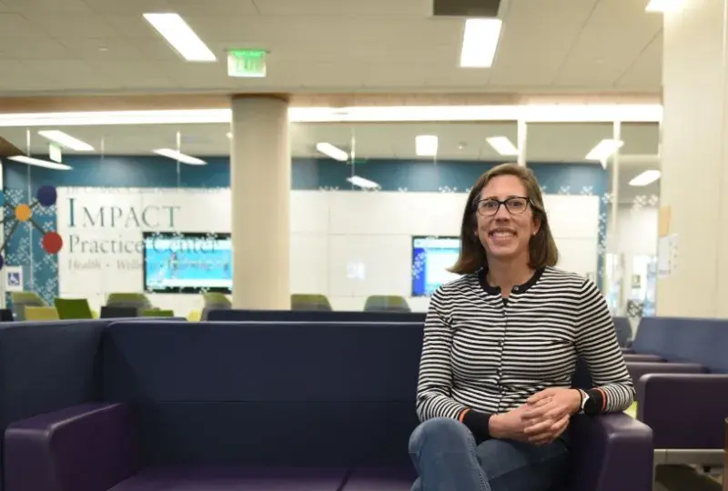 A woman sits on a couch