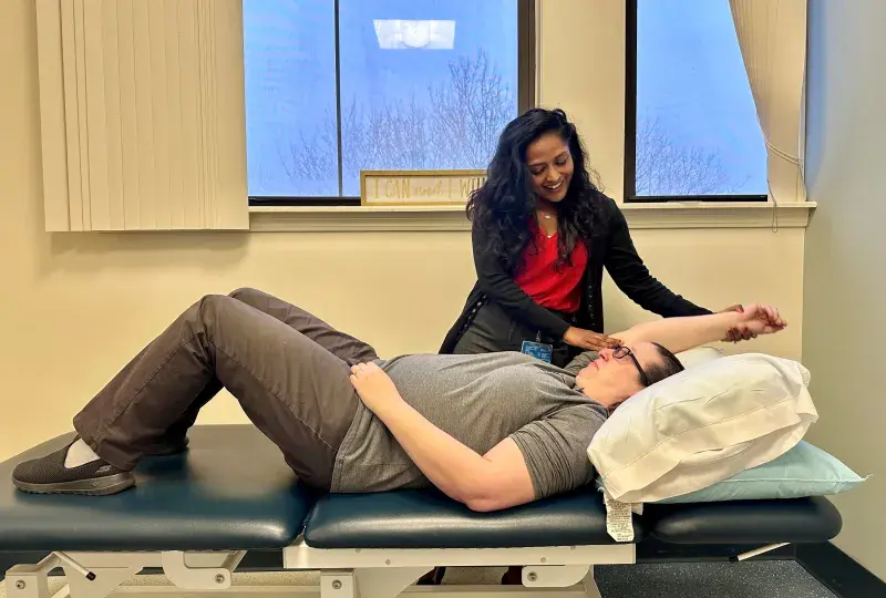 Physicla Therpist with patient on table 