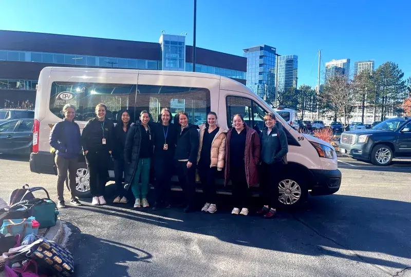 people standing in front of a van