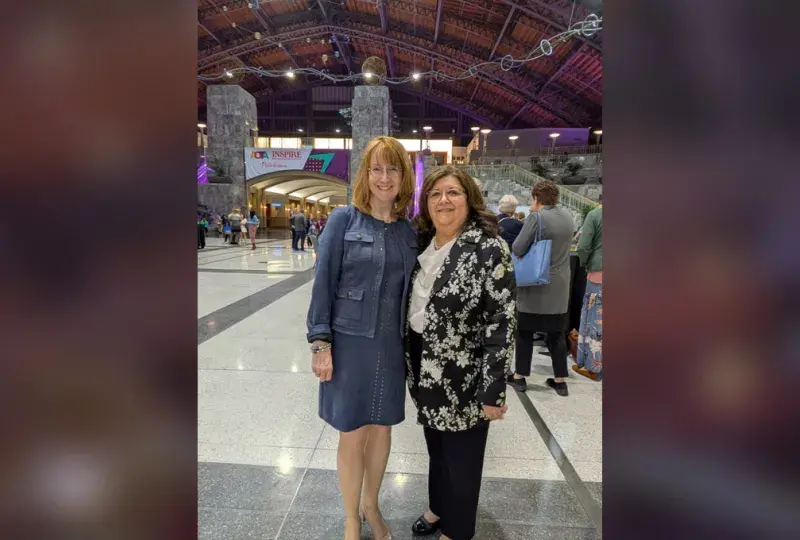 Two women pose for the camera