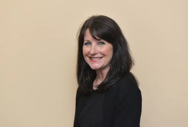 A photo of a woman smiling.