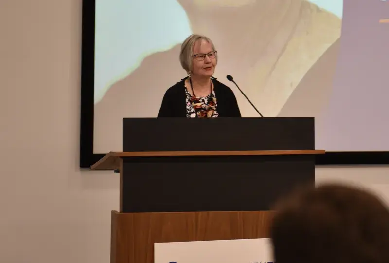 A photo of a woman at a podium