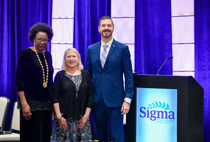 Nicholas posing with woman and man 