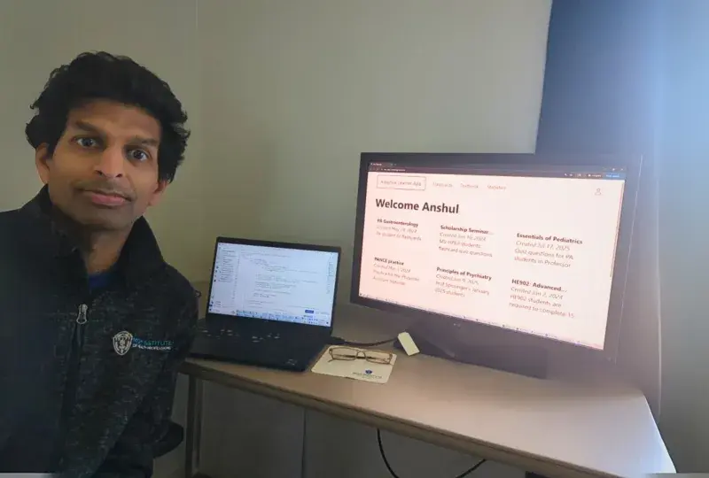 a photo of a man in front of a computer