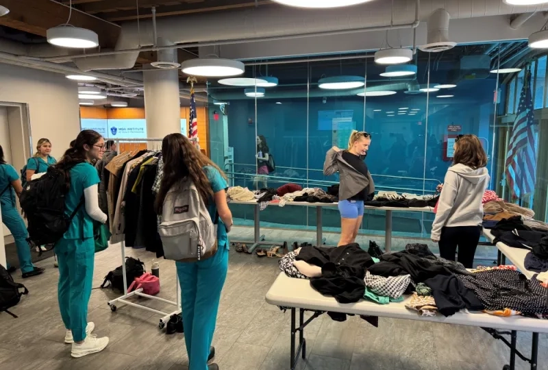 4 women around piles of clothes