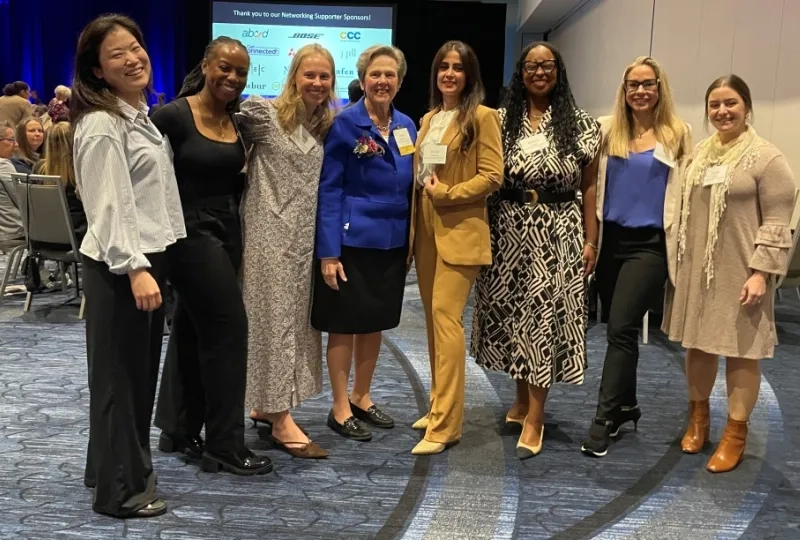 Eight women pose for a photo