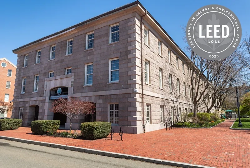 A stone building with a graphic that says LEED Gold 