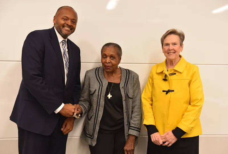 Three people pose for a photo