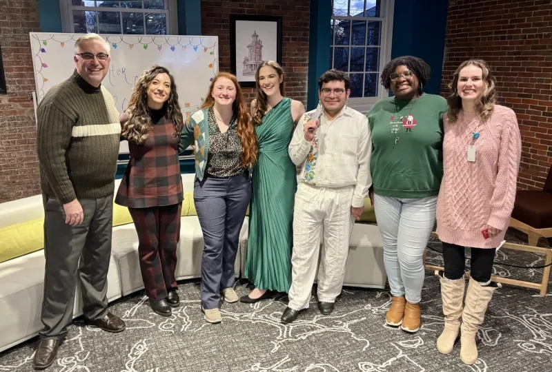 group of men and women smiling